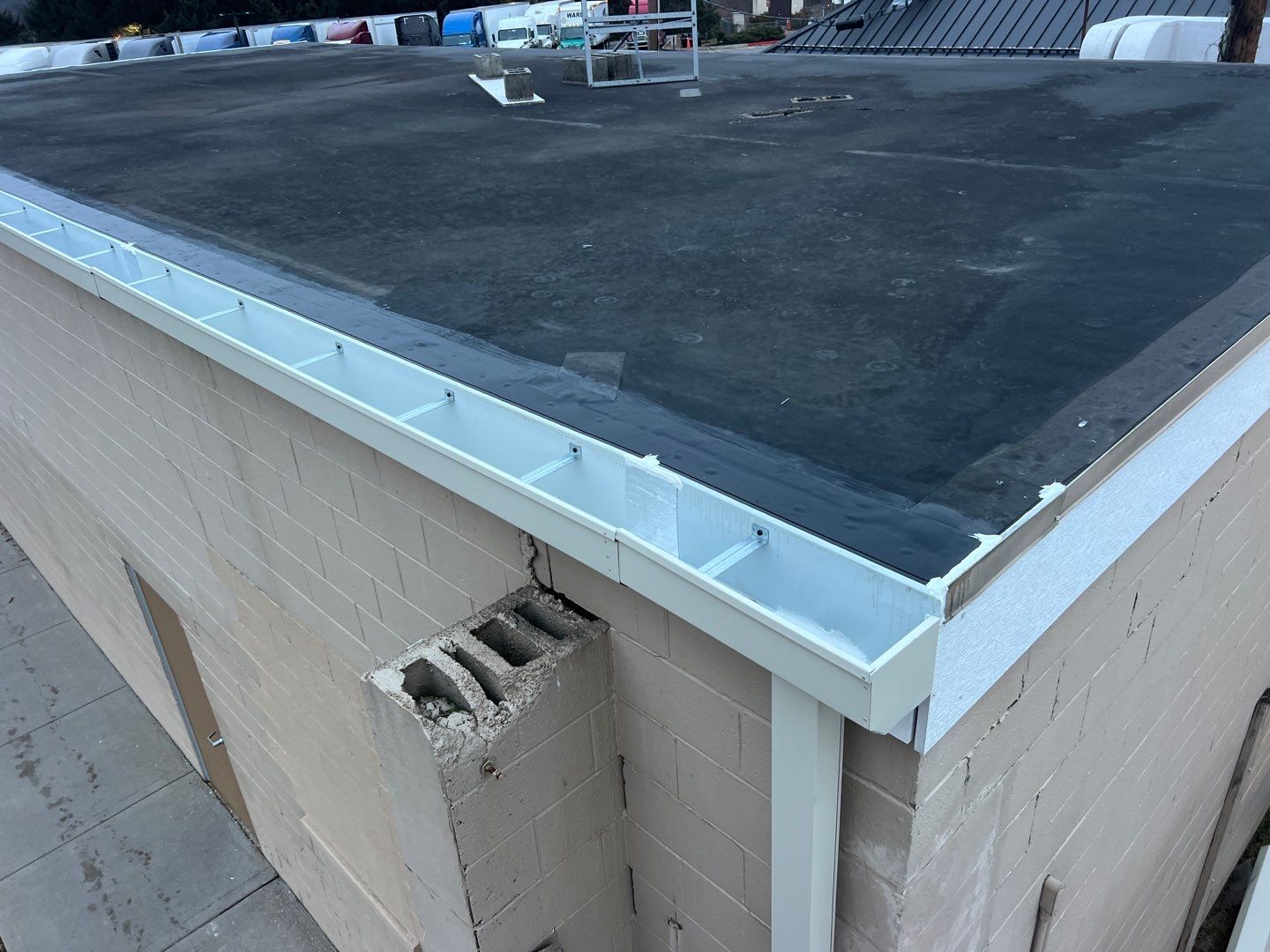 Commercial box gutters installation on a flat roof