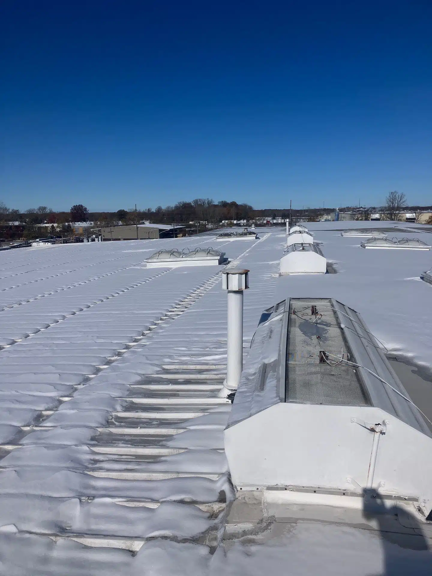 Winter damage on a Pennsylvania commercial roof needing replacement